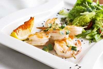 Close-up of fish served in plate on table