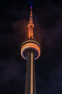 Low angle view of communications tower against sky at night