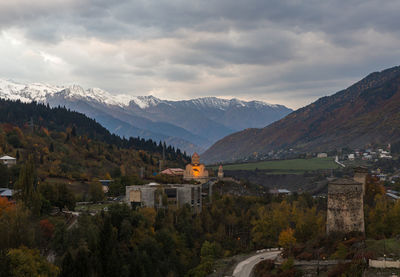 Scenic view of mountains and houses against sky