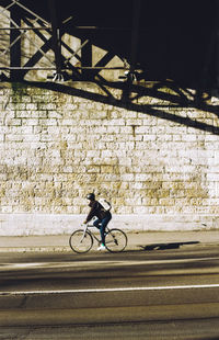 Man riding bicycle on city street