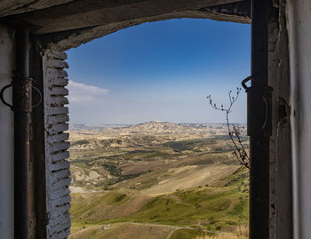 Scenic view of mountains seen through window of building