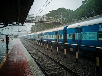 Train at railroad station against sky