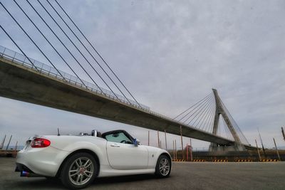 Car on bridge against sky