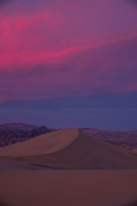 Scenic view of desert against sky during sunset