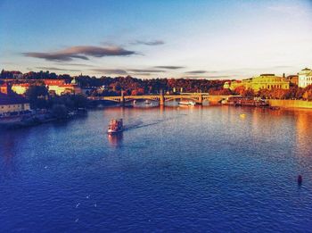 Boats in river with buildings in background