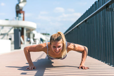 Portrait of young woman exercising in gym