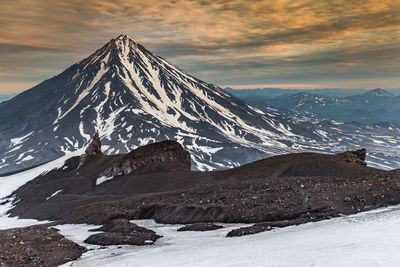 Scenic view of snowcapped mountains against sky during sunset