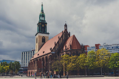 Low angle view of church against cloudy sky