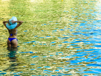 Rear view of woman in water