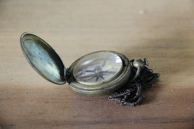 Close-up of old glass container on table