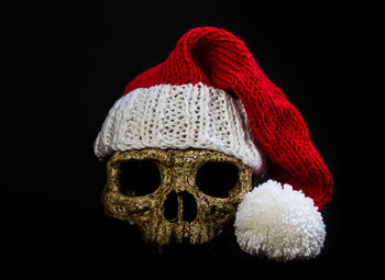 Close-up of hat against black background
