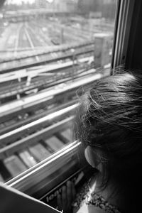 High angle view of girl looking through train window