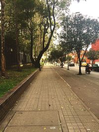 Cars parked on footpath in city