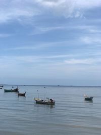 Boats in sea against sky