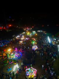 High angle view of illuminated carousel at night