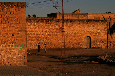 People walking on old building