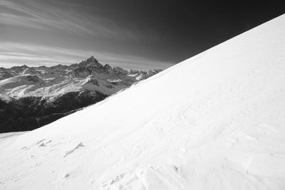 Scenic view of snow covered mountains against sky