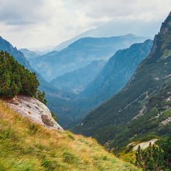 Scenic view of valley and mountains against sky