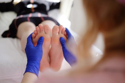 Masseuse massaging woman at health spa