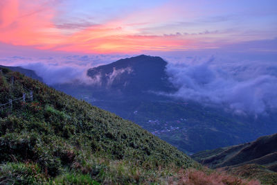 Scenic view of mountains against sky at sunset