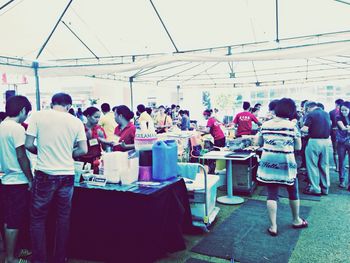 People working at market stall
