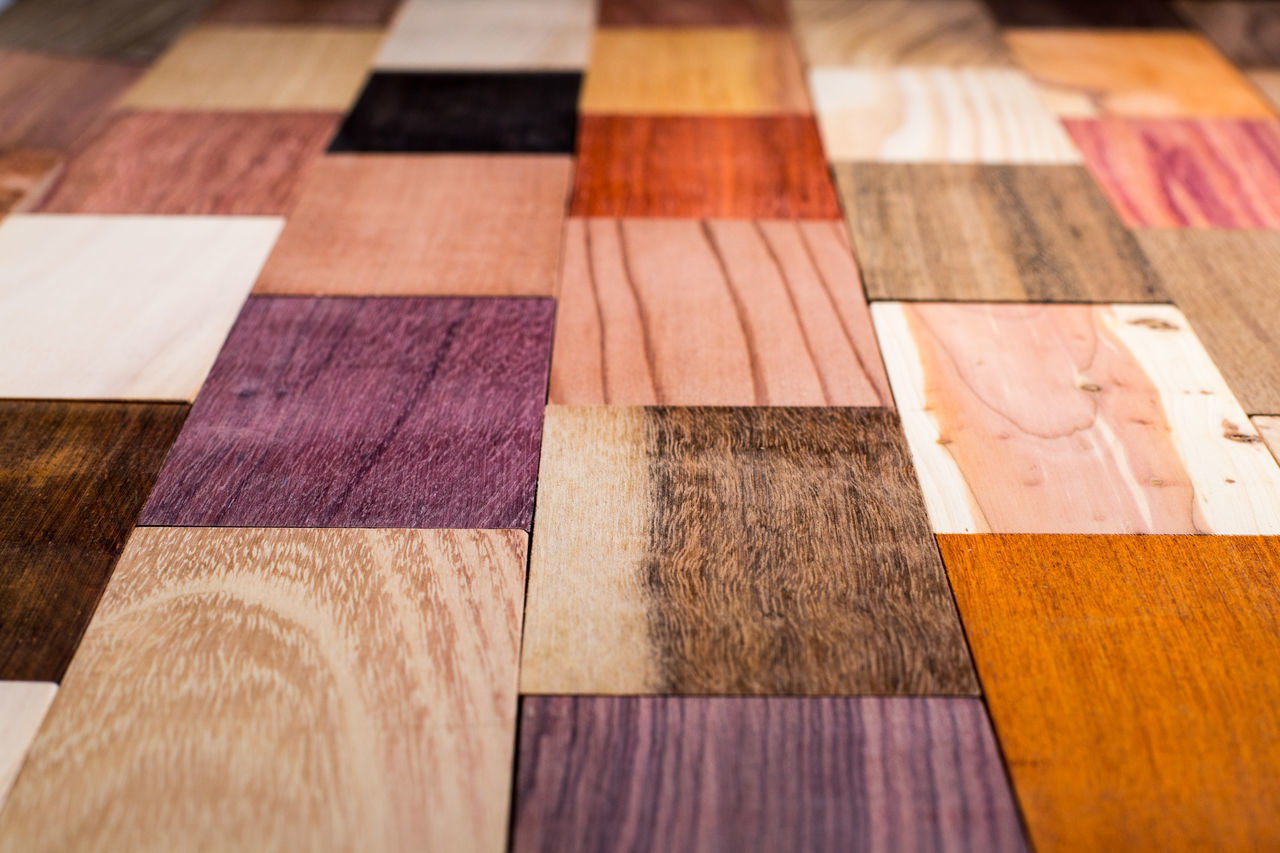 CLOSE-UP OF MULTI COLORED WOODEN TABLE