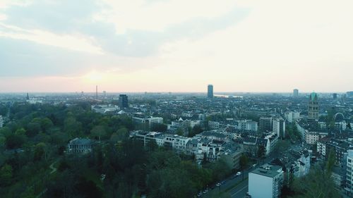 High angle view of city buildings against sky during sunset