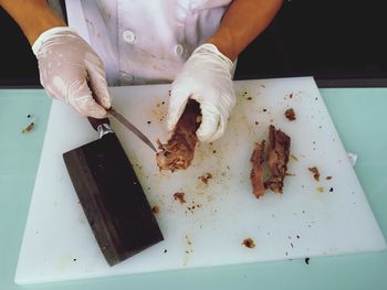 Close-up of person preparing food on cutting board
