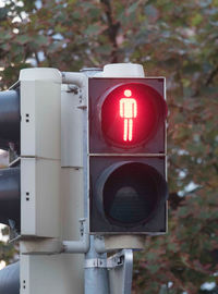 Red traffic light for pedestrians, stop sign in road traffic