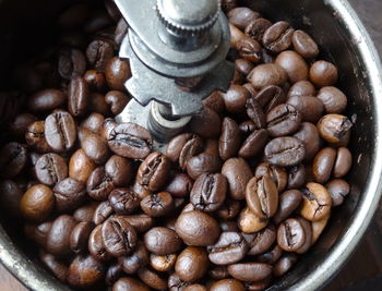 Close-up of coffee beans in coffee grinder