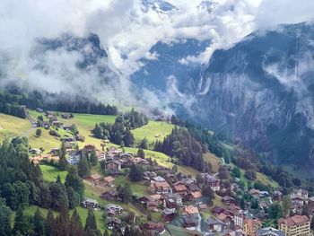 Aerial view of houses and trees against sky