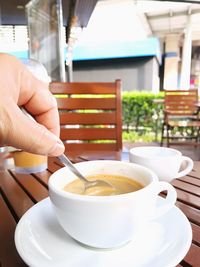 Cropped image of person holding coffee cup