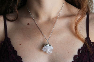 Midsection of woman wearing necklace