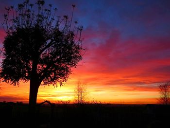 Silhouette of landscape against cloudy sky