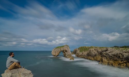 Panoramic view of rocks in sea against sky