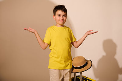 Portrait of young man standing against white background