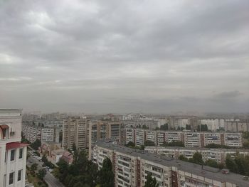 High angle view of buildings in city against sky