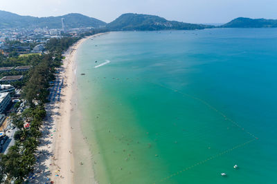 High angle view of sea and cityscape against sky