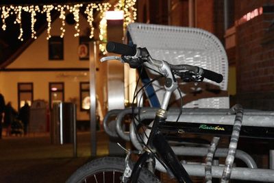 Close-up of bicycle parked on street against buildings