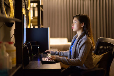 Side view of woman using mobile phone