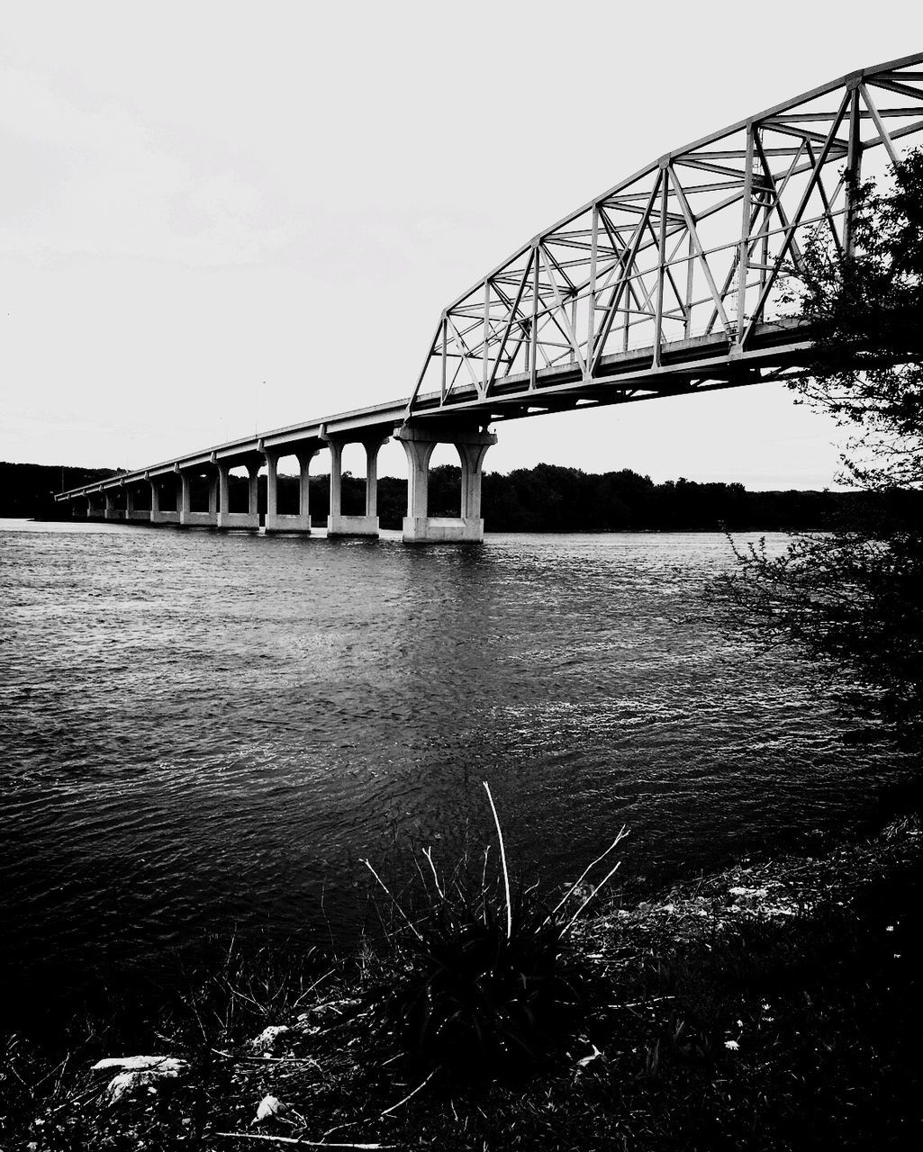 built structure, architecture, water, connection, bridge - man made structure, river, engineering, bridge, clear sky, sky, waterfront, reflection, travel destinations, transportation, outdoors, nature, low angle view, arch bridge, no people, day