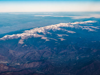 Aerial view of snowcapped mountains against sky