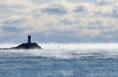 Scenic view of sea against cloudy sky