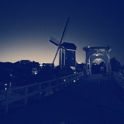 Traditional windmill against clear sky at dusk