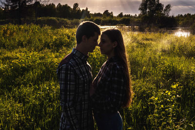 Young couple standing on field