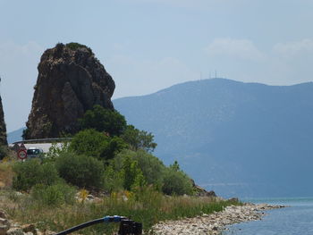 Scenic view of sea and mountains against sky