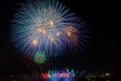 Low angle view of firework display at night