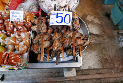 High angle view of fresh frogs with label at market stall