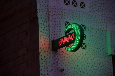 Close-up of illuminated text on wall