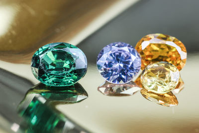 Close-up of multi colored glass diamonds on table